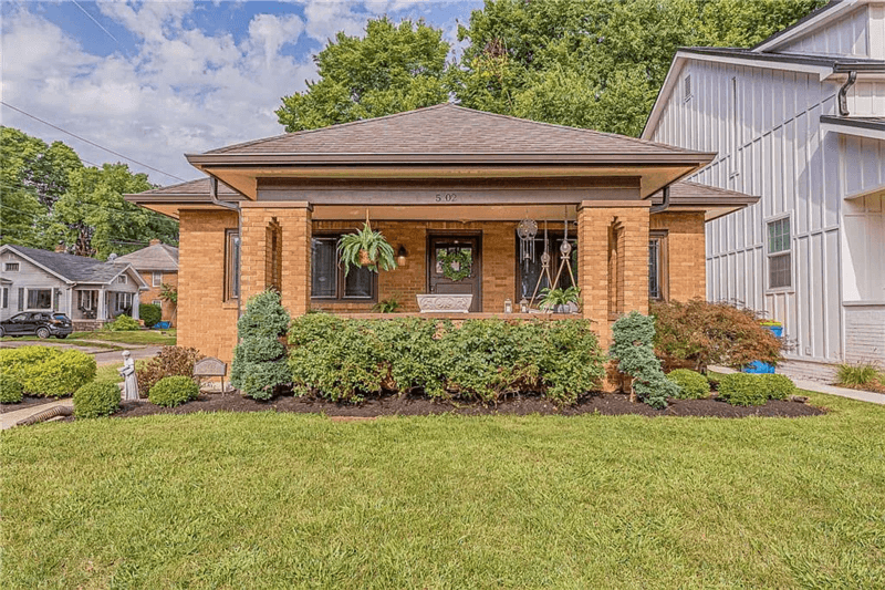 Managed single-family home with trimmed lawn and front porch